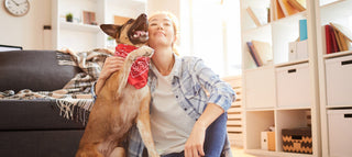 a woman and her dog sitting in a living room