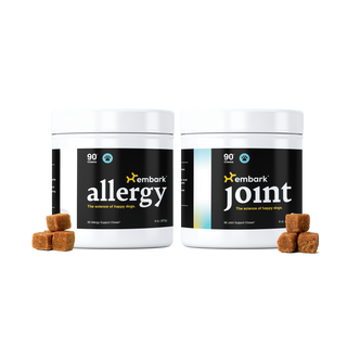 Two white plastic supplement tubs labeled embark allergy and embark joint, shown side by side on a white background with small brown chew cubes placed in front of each tub.
