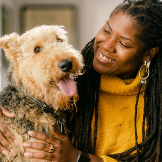 an embark employee with her airedale terrier