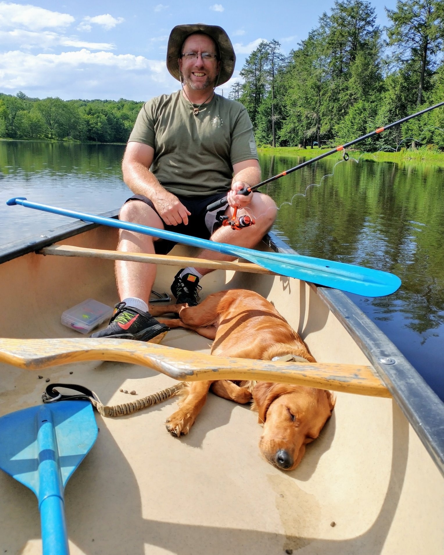 stand with me handler and dog in rowboat on lake